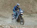 Chris riding in the muddy conditions in Tunisia Africa racing the 2005 Optic 2000 Rally. FREE Wallpaper